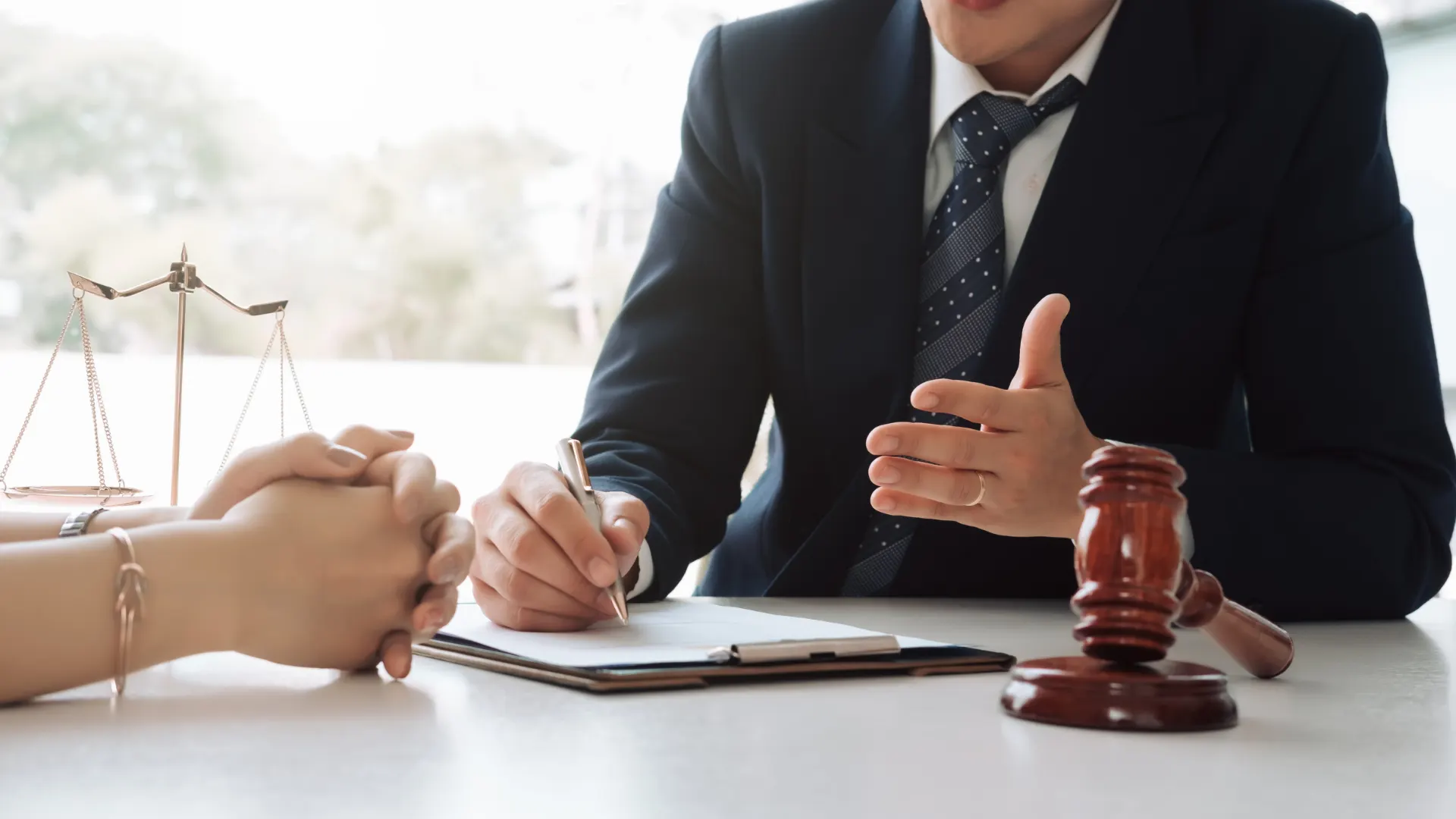 Omaha truck accident lawyer shaking hands with a client over an office table in Nebraska.